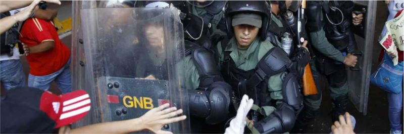Guardas venezuelanos confrontam manifestantes anti-governo em protesto em Caracas, em foto de 12 de abril de 2014 